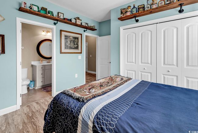 Full bath with double vanity, tile patterned flooring, a sink, and baseboards | Image 22