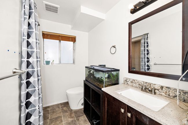Full bath featuring toilet, baseboards, vanity, and a shower with curtain | Image 23