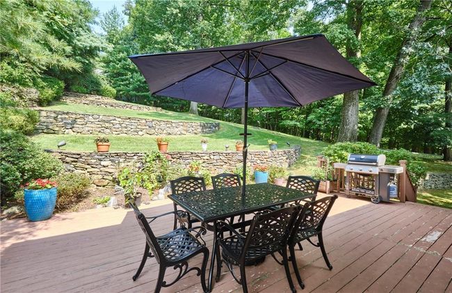 Wooden deck with grilling area and a yard | Image 8