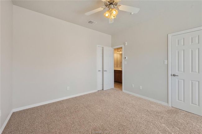 Unfurnished bedroom with light colored carpet, baseboards, a ceiling fan, and visible vents | Image 20