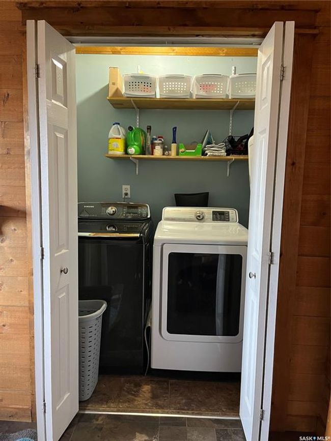 Laundry area featuring stone finish flooring, laundry area, and washing machine and dryer | Image 27