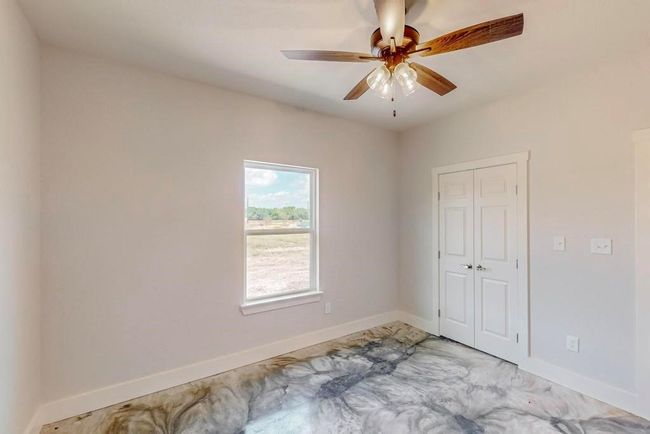 Empty room featuring baseboards and a ceiling fan | Image 25