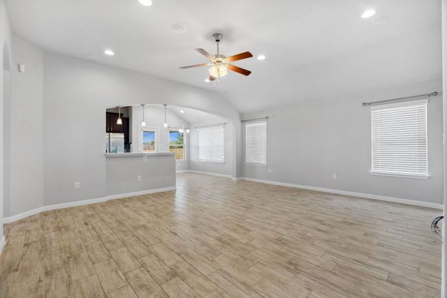 Multiple windows provide abundant natural light and all have blinds as window treatments. | Image 6