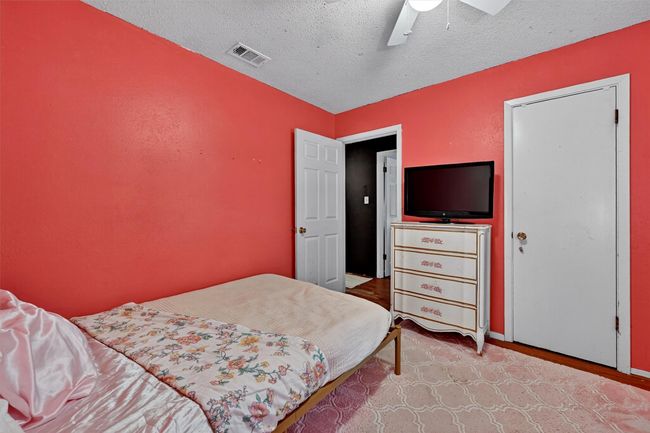 Bedroom featuring a textured ceiling and a ceiling fan | Image 21