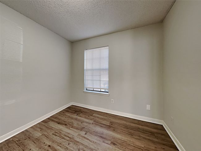 Spare room featuring wood finished floors and a textured ceiling | Image 13