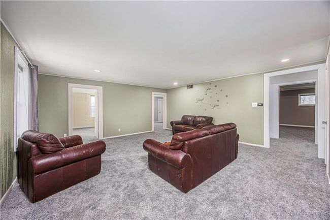 Carpeted living room with recessed lighting and baseboards | Image 30