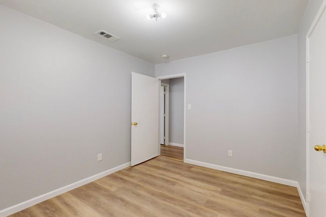 Empty room with visible vents, baseboards, and light wood-style floors | Image 21