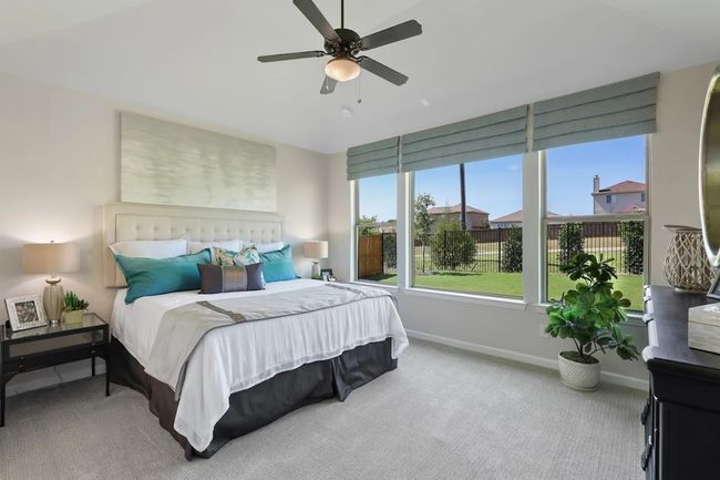Bedroom featuring carpet, baseboards, ceiling fan, and lofted ceiling | Image 14