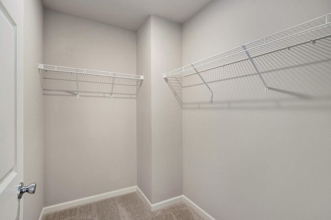 The luxurious primary suite includes a private bath and large walk-in closet. | Image 14