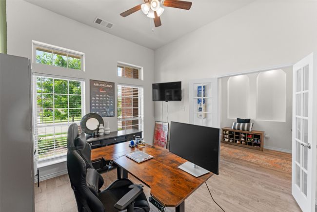 Office featuring plenty of natural light, ceiling fan, a towering ceiling, and light wood-type flooring | Image 19