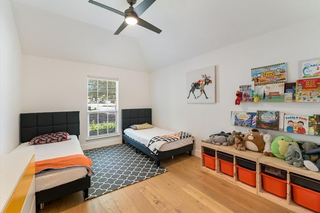 Bedroom with wood finished floors, lofted ceiling, and ceiling fan | Image 19