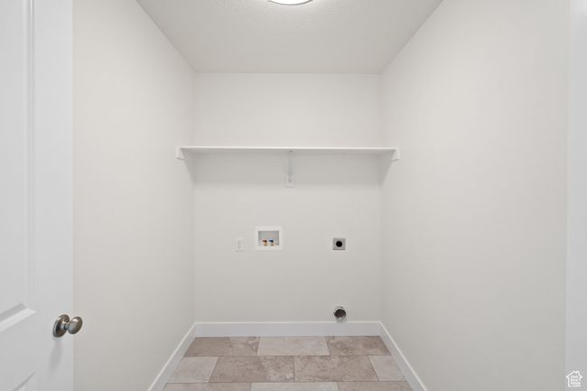Laundry area with hookup for an electric dryer, washer hookup, and a textured ceiling | Image 15