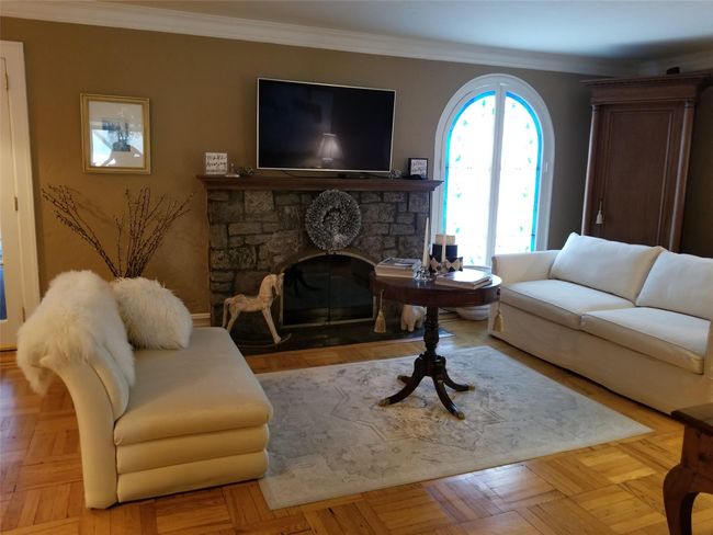 Living area featuring a fireplace and crown molding | Image 12