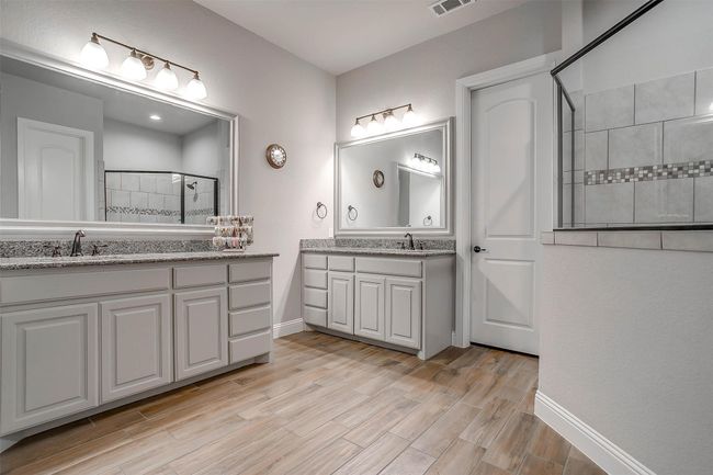 Full bath featuring tiled shower, vanity, and wood finished floors | Image 37