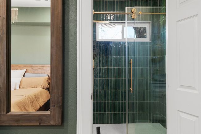 The primary bathroom is an oasis in itself, offering a serene atmosphere with contemporary fixtures and elegant finishes | Image 17