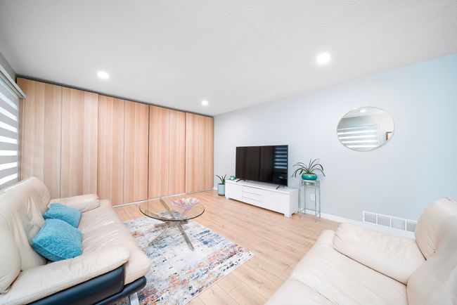 Living room with visible vents, recessed lighting, and light wood-type flooring | Image 12