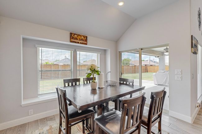 Dining room with baseboards, lofted ceiling, and light wood-style floors | Image 11