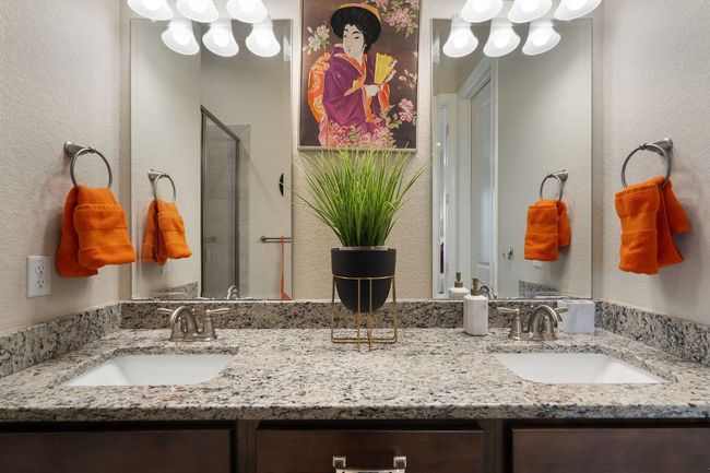 2nd Floor Primary Bathroom with a textured wall, double vanity, a sink, and a shower stall | Image 23