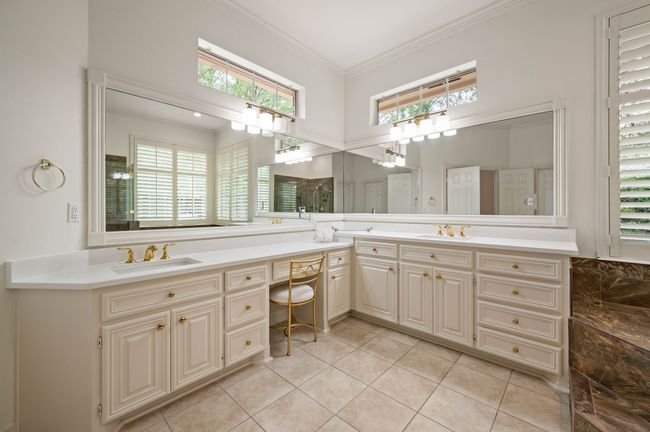 Full bathroom with double vanity, ornamental molding, a sink, and tile patterned floors | Image 28