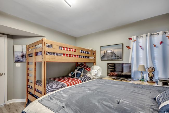 Bedroom with wood finished floors and baseboards | Image 23