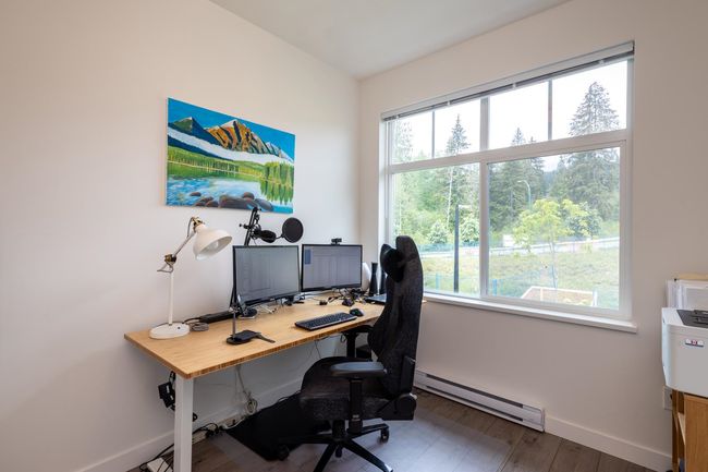 Home office featuring baseboard heating, baseboards, plenty of natural light, and wood finished floors | Image 20