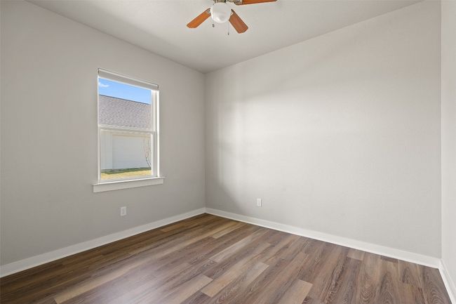 Unfurnished room with wood finished floors, ceiling fan, and baseboards | Image 37