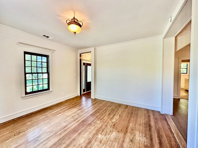 Unfurnished room with wood finished floors and crown molding | Image 5