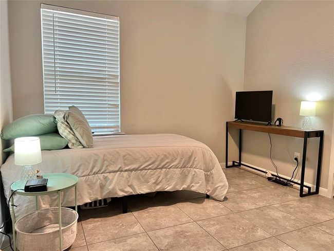 Discover one of the home's many spacious bedrooms, designed for comfort and style. | Image 15