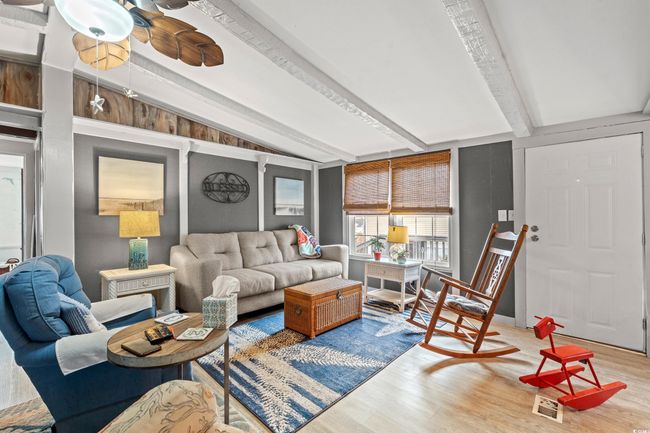 Living room with hardwood / wood-style floors and lofted ceiling with beams | Image 7