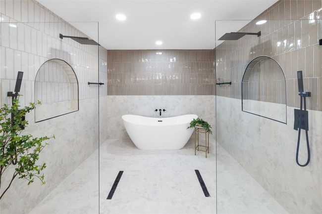 Full bathroom with tile walls, a walk in shower, a soaking tub, and recessed lighting | Image 31