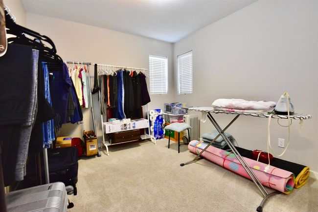 Spacious closet featuring carpet floors and radiator | Image 29