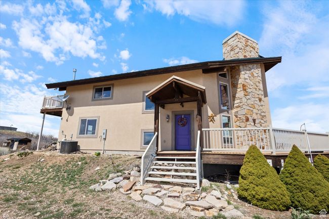 View of front facade featuring a chimney and stucco siding | Image 24