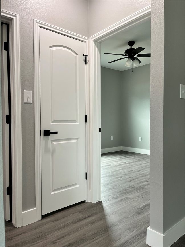 Hallway featuring wood finished floors and baseboards | Image 17