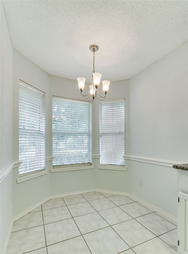 Breakfast area in the kitchen, front of the house featuring a bay window. | Image 16