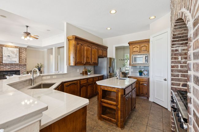 The kitchen is open to the living space, but there is also some separation with the ledge and wall. This allows you to keep the kitchen mess out of the line of sight! | Image 12