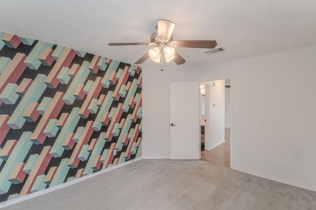 Carpeted spare room featuring a ceiling fan and a textured ceiling | Image 22