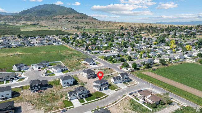 Aerial overview of property's location with mountains and nearby suburban area | Image 44