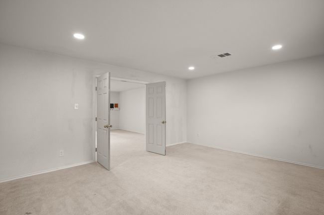 Basement featuring recessed lighting, baseboards, light colored carpet, and visible vents | Image 27