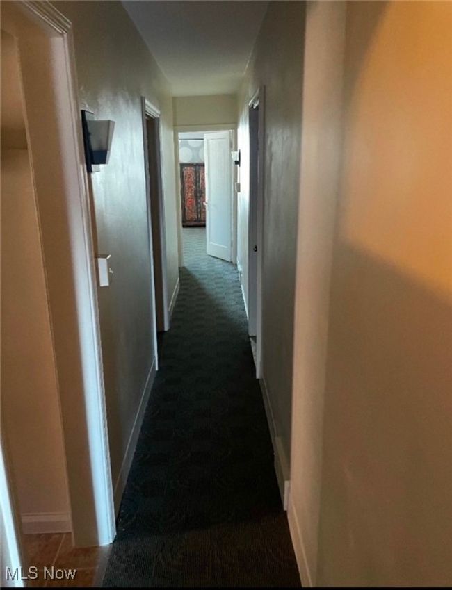 Hallway featuring dark colored carpet | Image 10