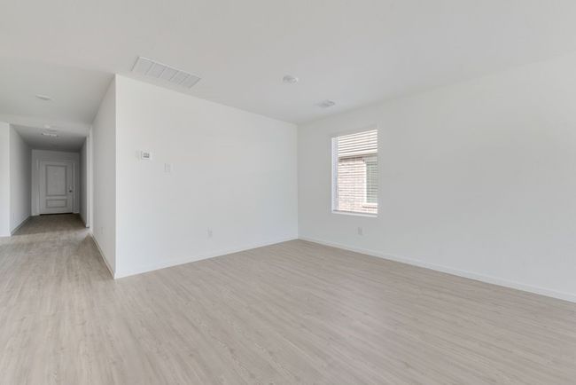 Empty room with light wood-style flooring and baseboards | Image 5
