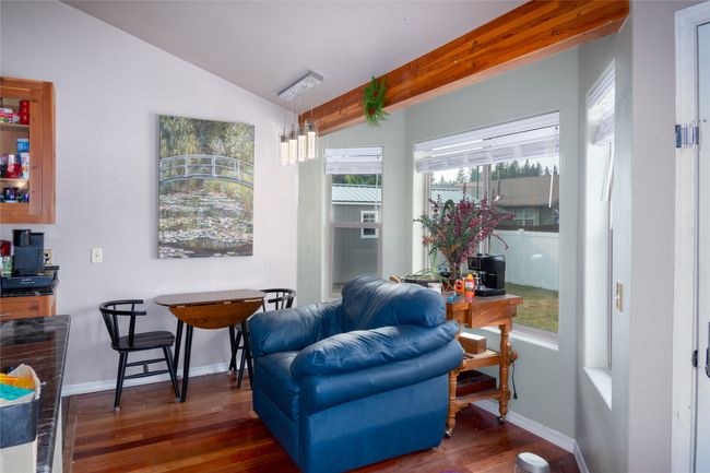 Sitting room featuring wood finished floors, lofted ceiling with beams, and baseboards | Image 39