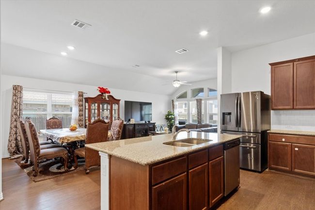 Kitchen with visible vents, a sink, dark wood-type flooring, and appliances with stainless steel finishes | Image 9