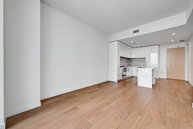 Unfurnished living room featuring baseboards, visible vents, recessed lighting, and light wood-style floors | Image 5