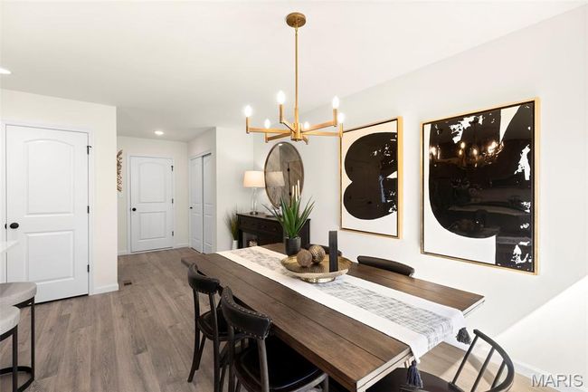 Dining area featuring a chandelier, wood finished floors, baseboards, and recessed lighting | Image 14