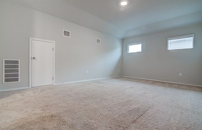 Carpeted empty room with visible vents and baseboards | Image 21