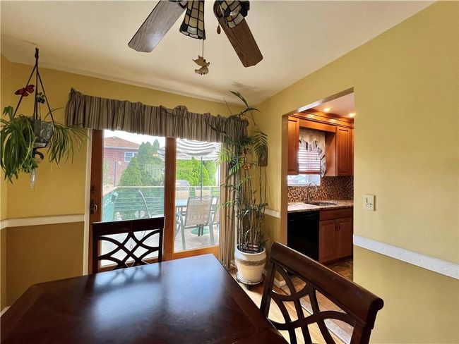 Dining area with sink and ceiling fan | Image 7