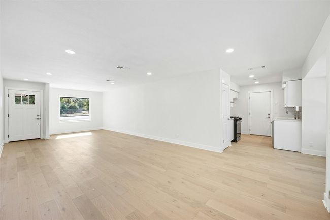 Unfurnished living room featuring light wood finished floors and recessed lighting | Image 11