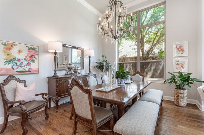 Dining area with ornamental molding, a RH chandelier, and wood finished floors | Image 10