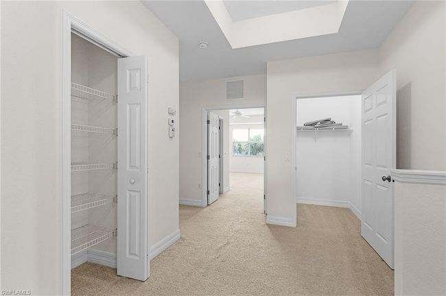 Hall with light colored carpet and a skylight | Image 19