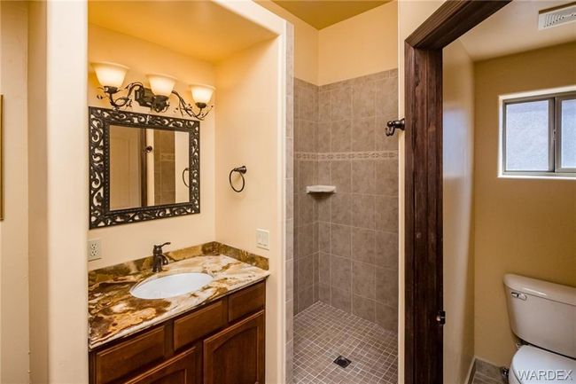 Bathroom featuring vanity and a tile shower | Image 59